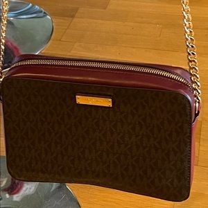 Wine colored Michael Kors logo bag. Gently used.